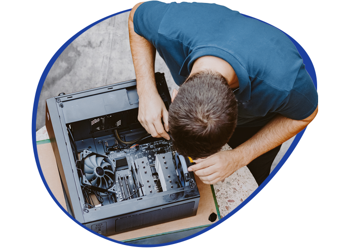 Birdseye shot of a young I.T. professional assempling a computer.